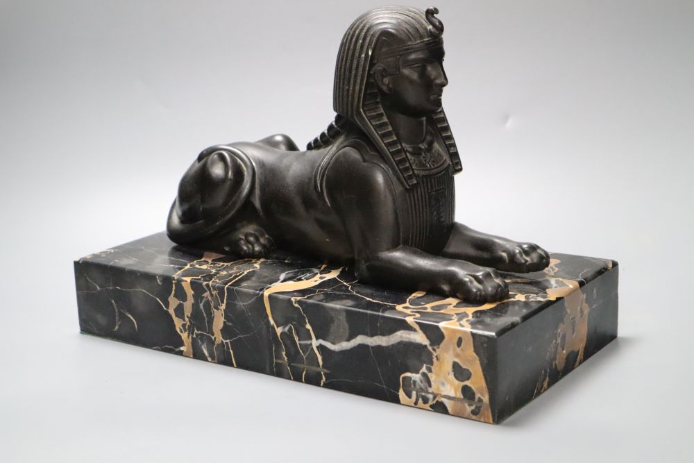 A bronzed spelter and marble sphinx, on marble plinth, height 32cm